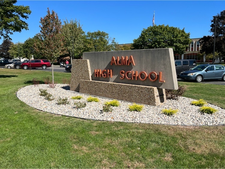 front of high school sign