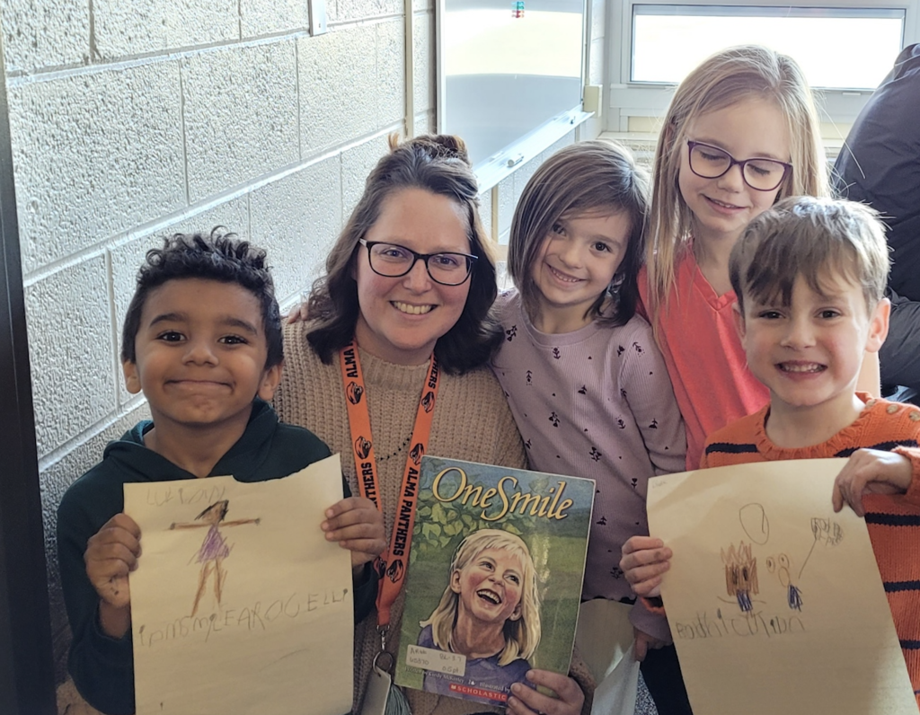 Teacher, Students holding pictures